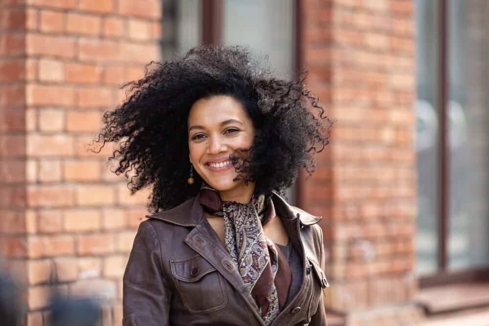 Stylish young African American woman with healthy-looking locks washed with Garnier Fructis daily shampoo