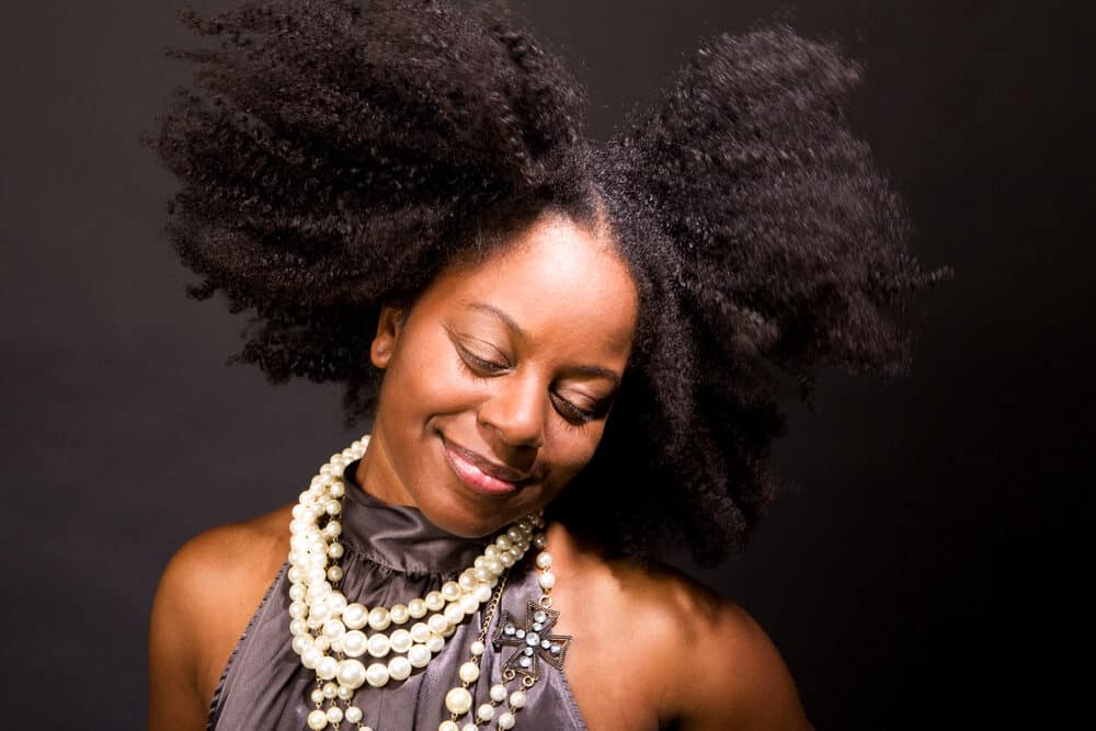 African American woman with great smile and long hair treated with argan oil