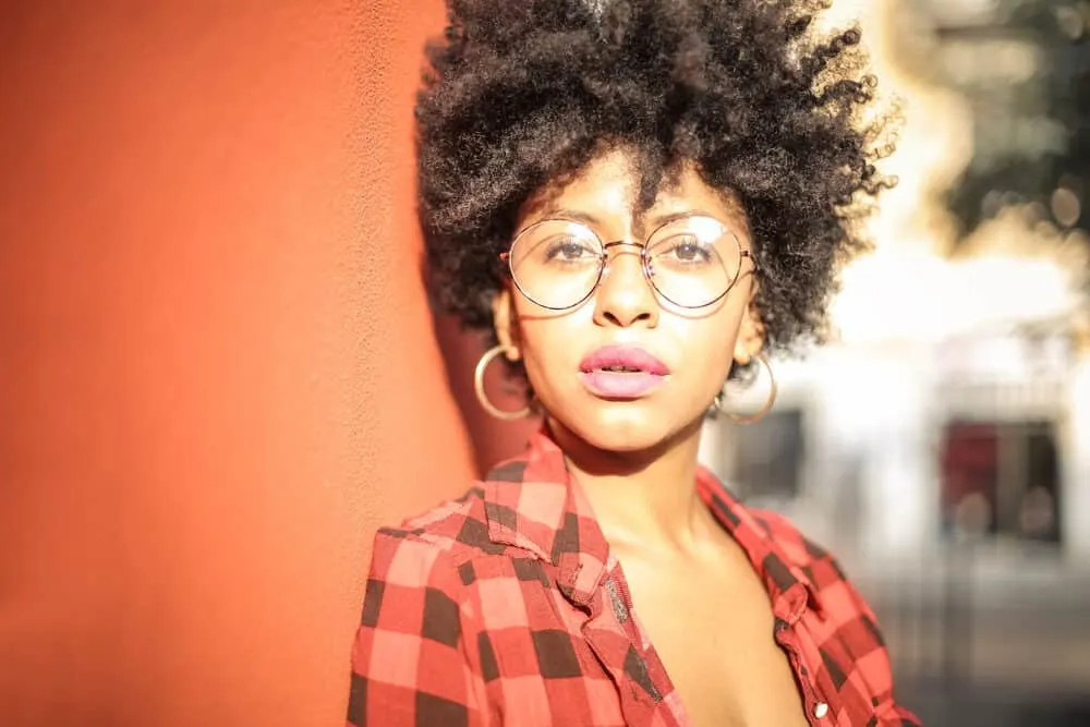 Drying Natural Hair Under a Hooded Dryer: Step-by-Step DIY Guide 1 Cute girl with a wash n go hairstyle created by air-drying her curls that's wearing a plaid dress shirt and red lipstick