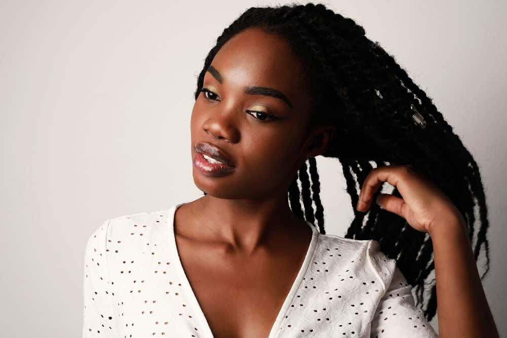 Black lady with natural curls braided into individual plaits