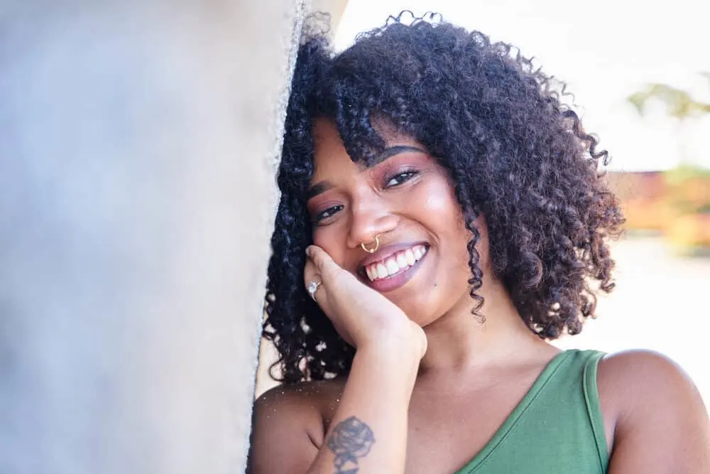 How To Get Aquaphor Out of Hair: 9 Easy Step-by-Step Solutions 8 Beautiful Latina girl with Vaseline in her type 3b curly hair strands