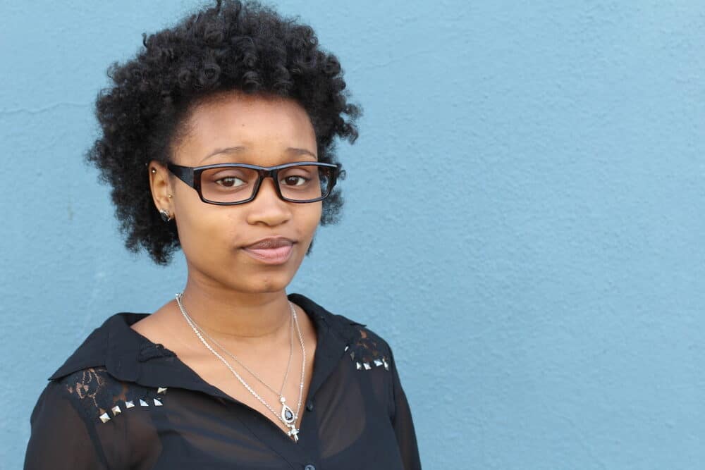 Black women with curls created from rollers overnight wearing black eyeglasses