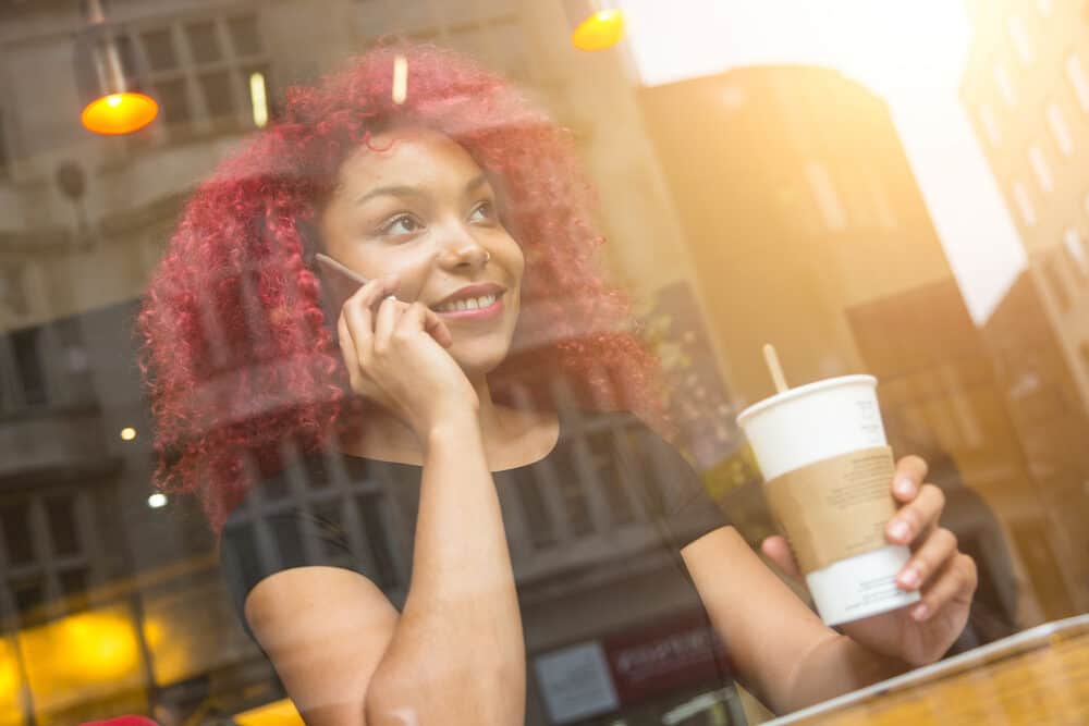 Beautiful African American girl with curly red-colored hair and light brown skin