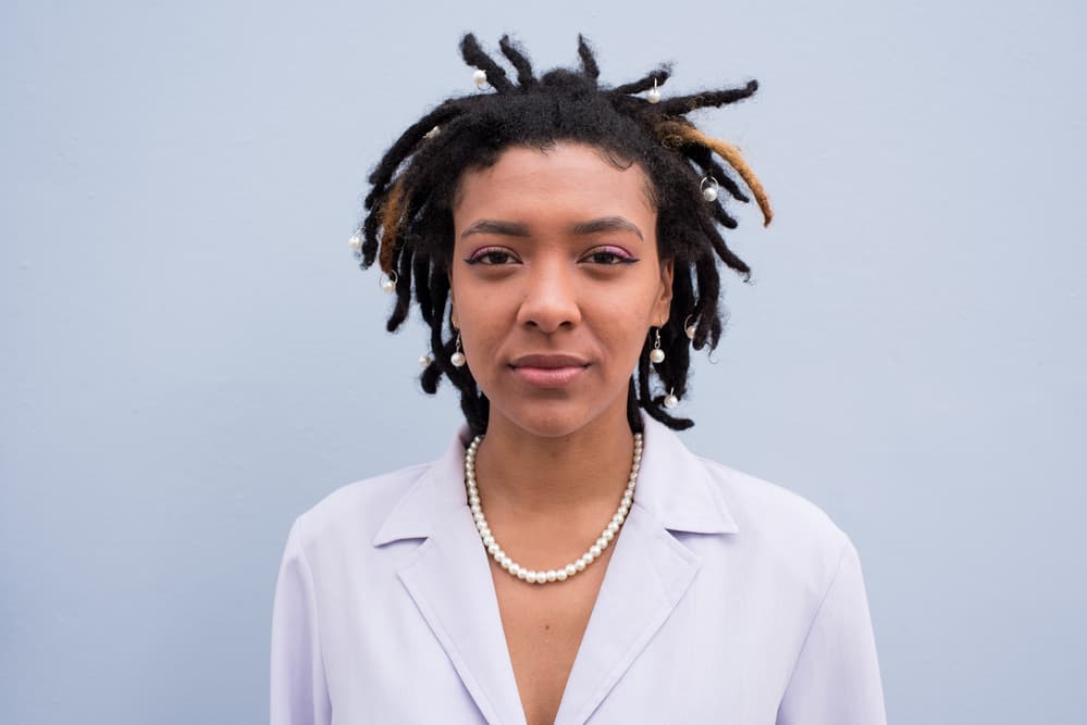 How To Get Lint Out of Dreads: Causes, Removal Methods, and Prevention Tips 1 Cute black girl wearing business clothing with a grayish tinge and ombre dreadlocks