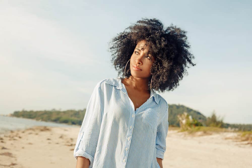 Beautiful African American female with long curly hair that uses Vicks vapor rub to grow hair