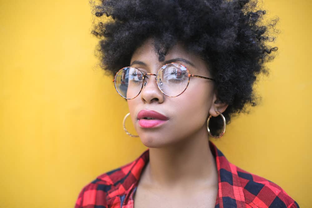 Close-up headshot of a black girl with a wash and go curly style on 4C strands created with direct heat