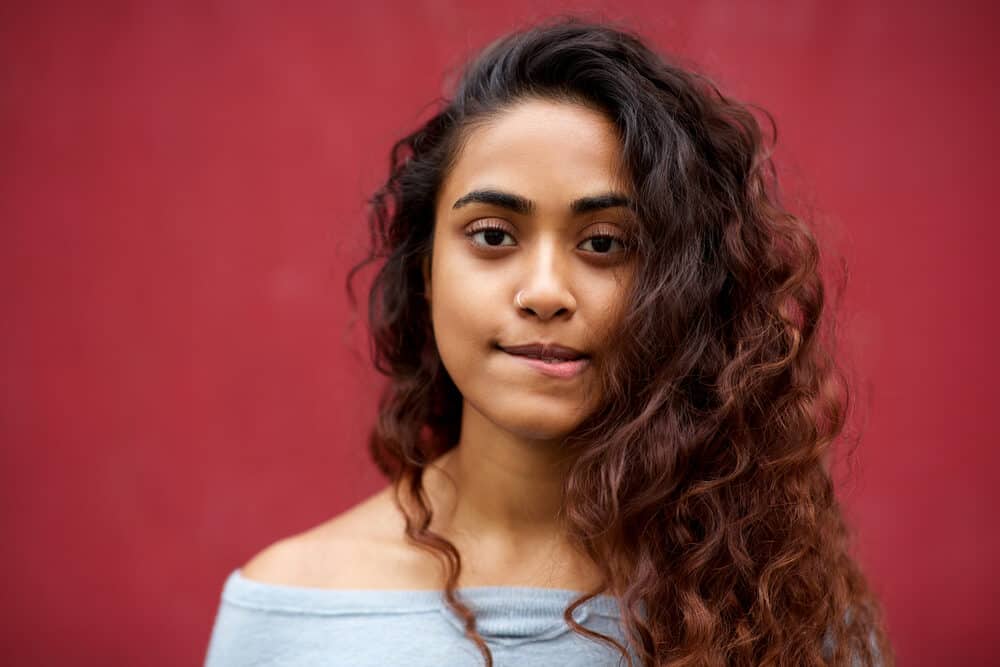 Young Indian woman with midnight shadows blue balayage hairstyle