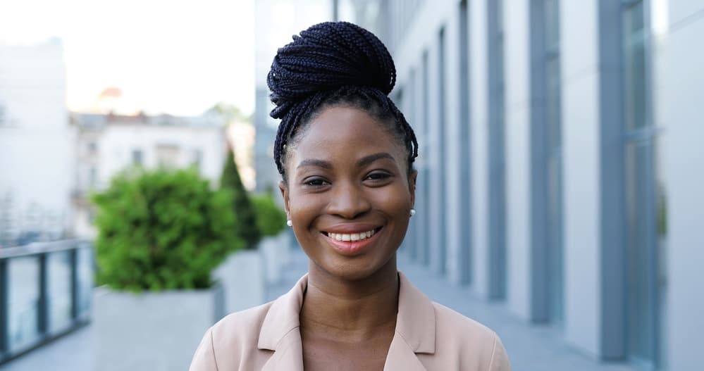 Pretty black lady wearing red lipstick and smaller braids in an updo style