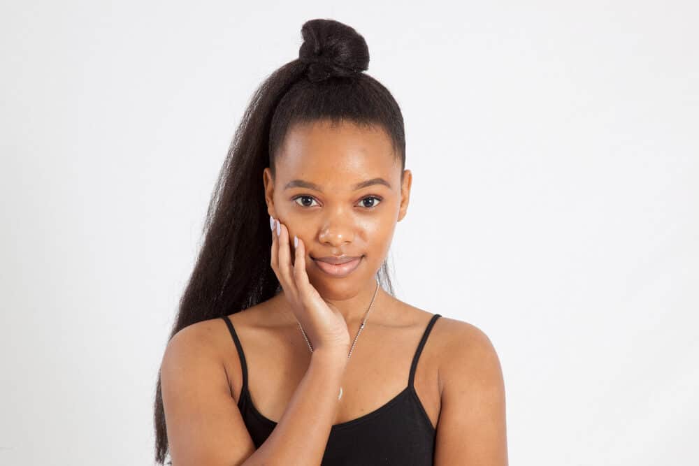 Light-skinned female looking directly into the camera with straight hair that has been flat ironed