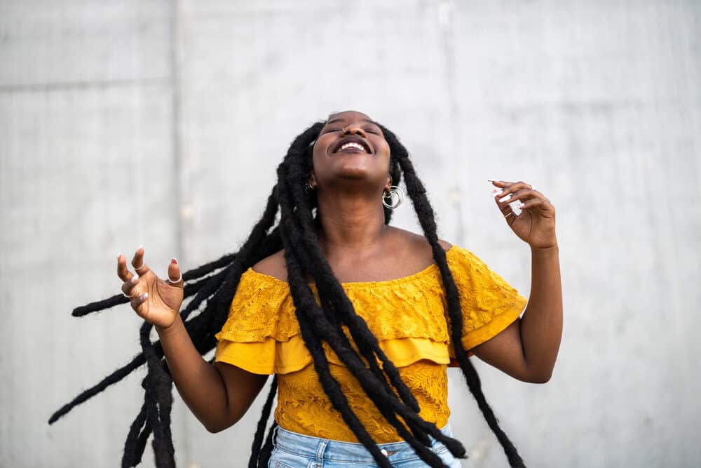 Cute young lady with thick fully mature dreads created using palm rolling