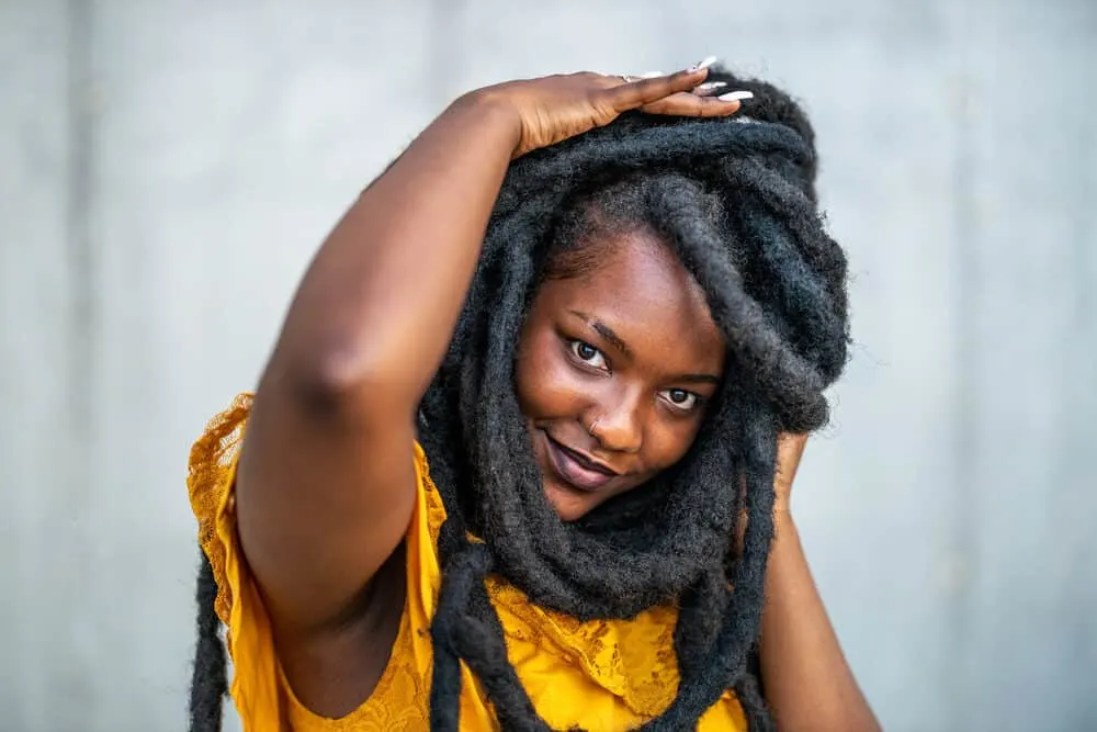 African woman having fun playing with her dreads