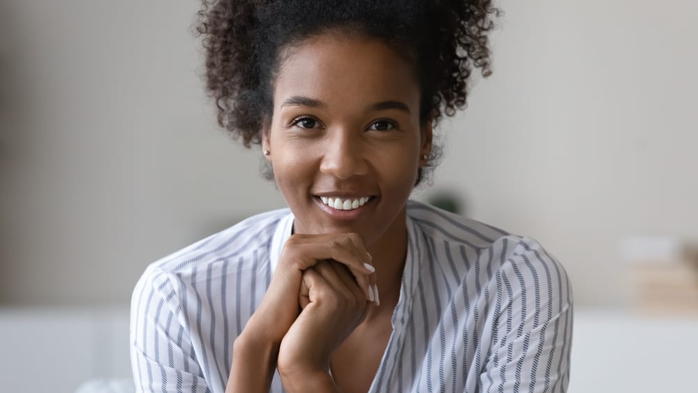 Black girl with a gorgeous smile and naturally curly hair