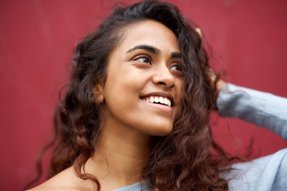 Young beauty with bright and bold balayage hairdo on naturally wavy hair