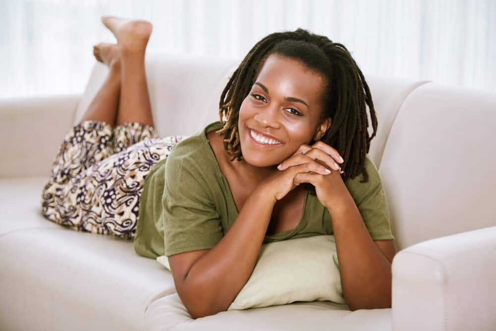 Beautiful smiling woman with brushable hair on top of her head and dreads on the back