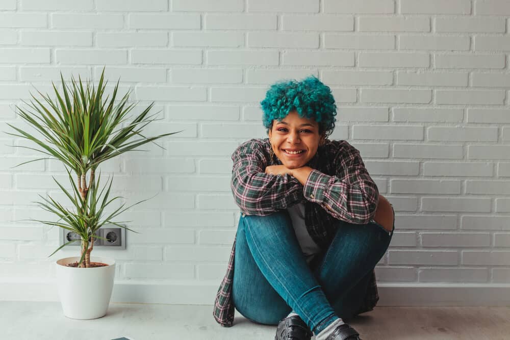 Young Afro American lady with an indigo mixture hair dye with blue jeans