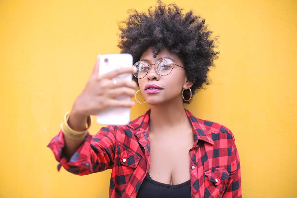 Pretty young lady wearing a curly fro created with gentle heat from a bonnet hair dryer