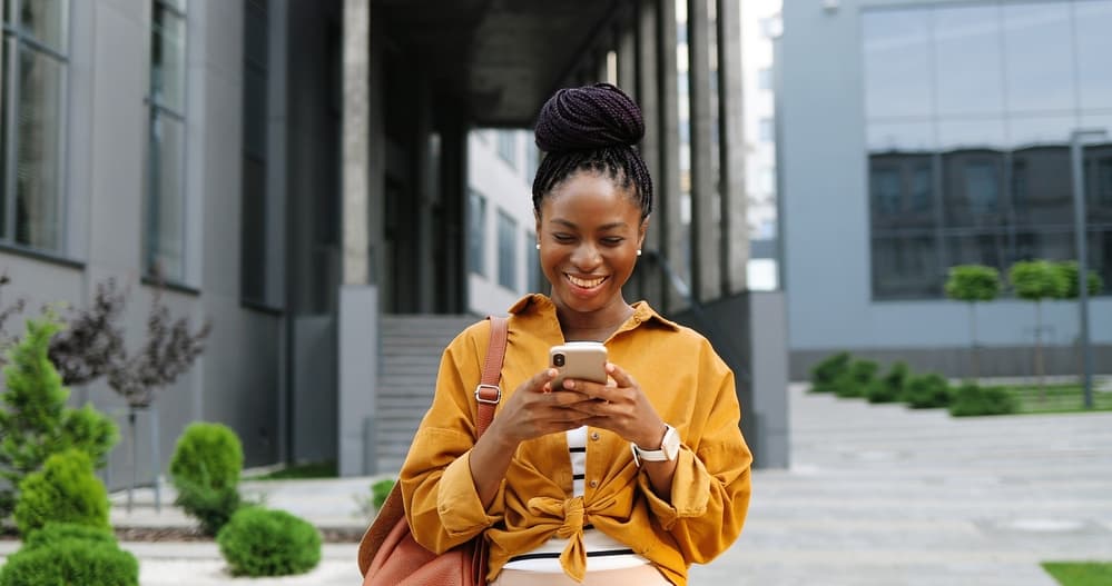 Stylish African American woman leaving the hair salon looking to relieve tight box braids