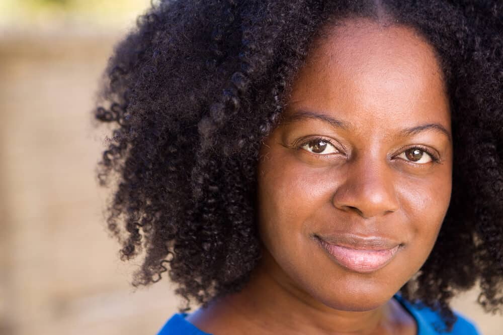 African American woman with dry hair gently detangled her rats nest before this photo