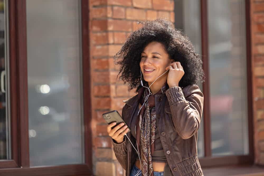 Attractive African American girl enjoying music with headphones