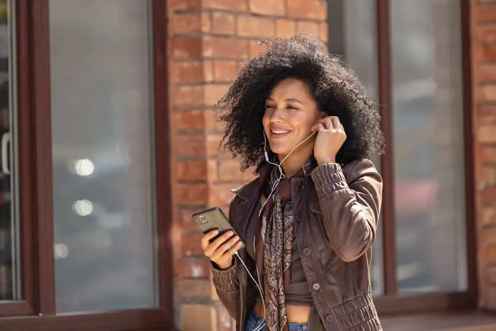 Attractive African American girl enjoying music with headphones