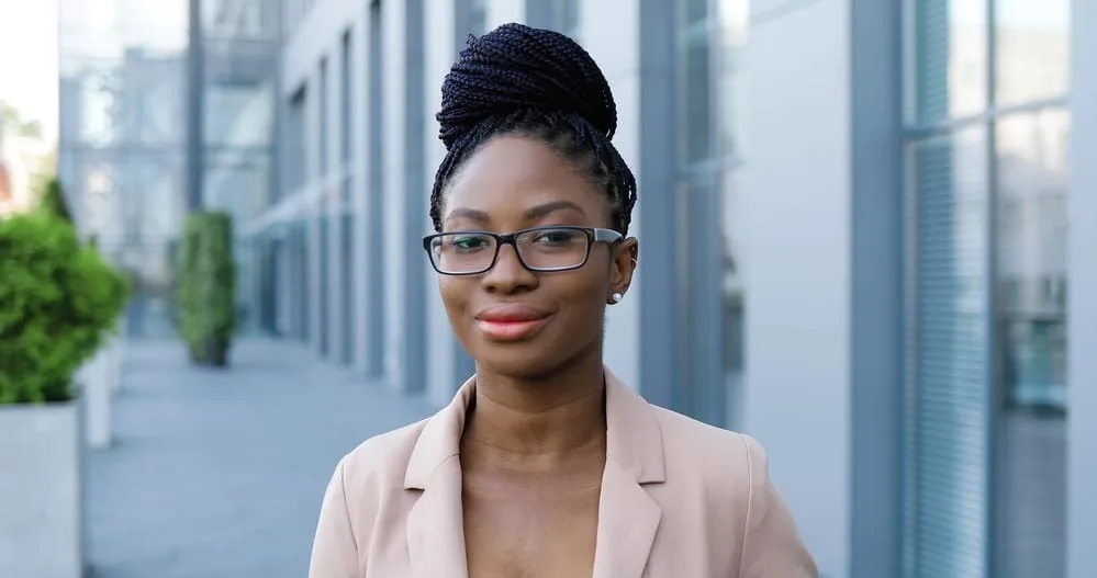 How To Relieve Tight Braids Causing Headaches, Pain, Bumps, and More 4 Young African American female with traction alopecia leaving her hair stylist after getting Senegalese twists