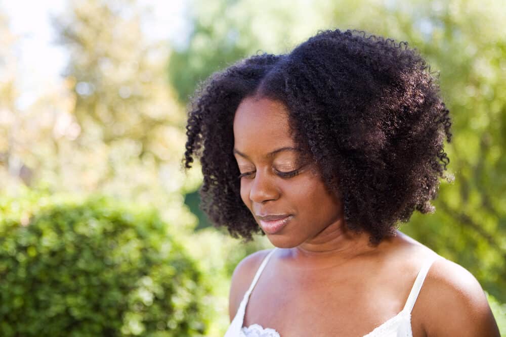 African American lady with a Rezo hair cut working in her garden