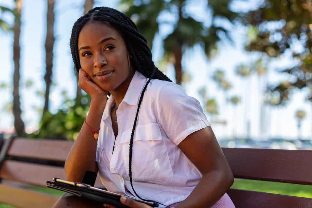 Beautiful black college girl with box braids, a fast hairstyle that's perfect for a college campus