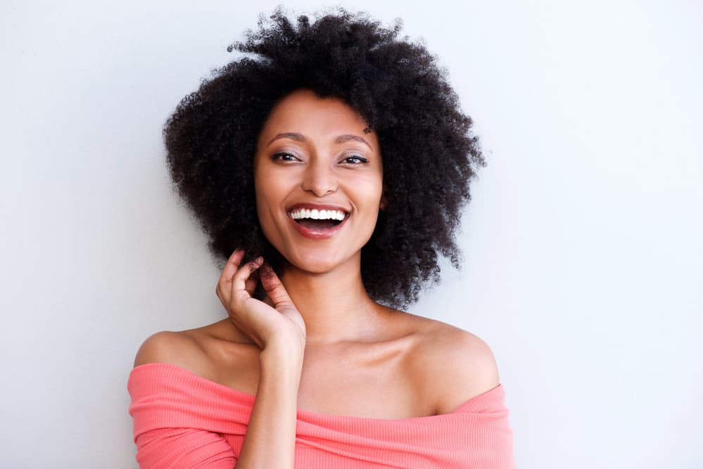 Cute girl with a light brown skin color with hair that appears to be black - the darkest hair color