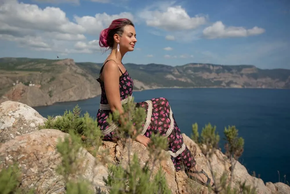 How To Remove Pink Hair Dye: DIY Guide to Get the Pink Color Out 6 Beautiful girl with pink semi-permanent colour (color) hair dye sitting outside near the ocean