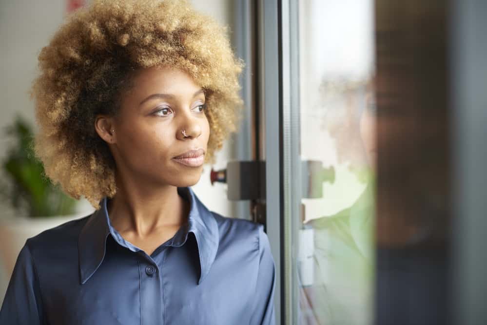 Young black girl with naturally dark hair that has been dyed blonde by a professional hair colorist.