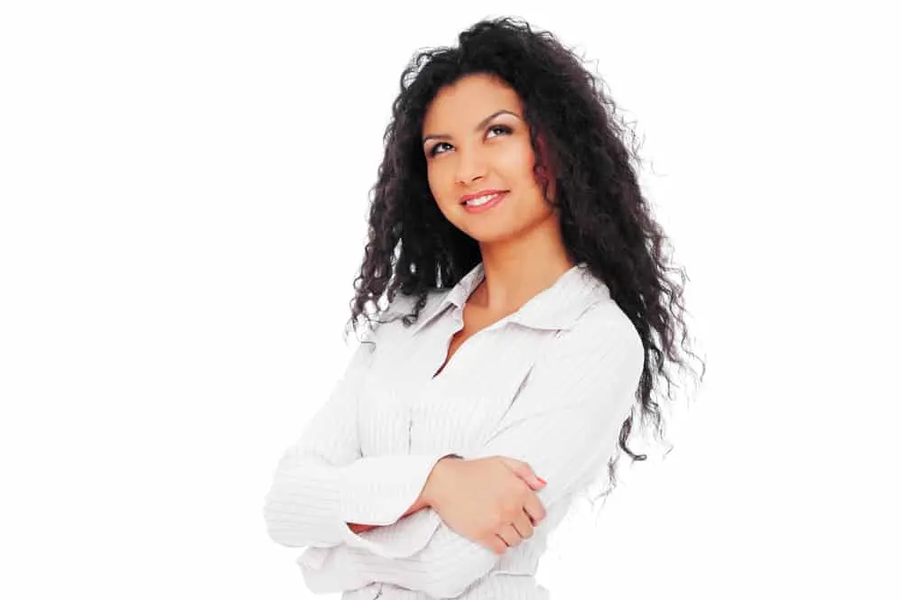 Why Does My Hair Smell Like Wet Dog? How To Get Rid of the Smell 6 A confident lady wearing business clothes with face make-up and her arms folded