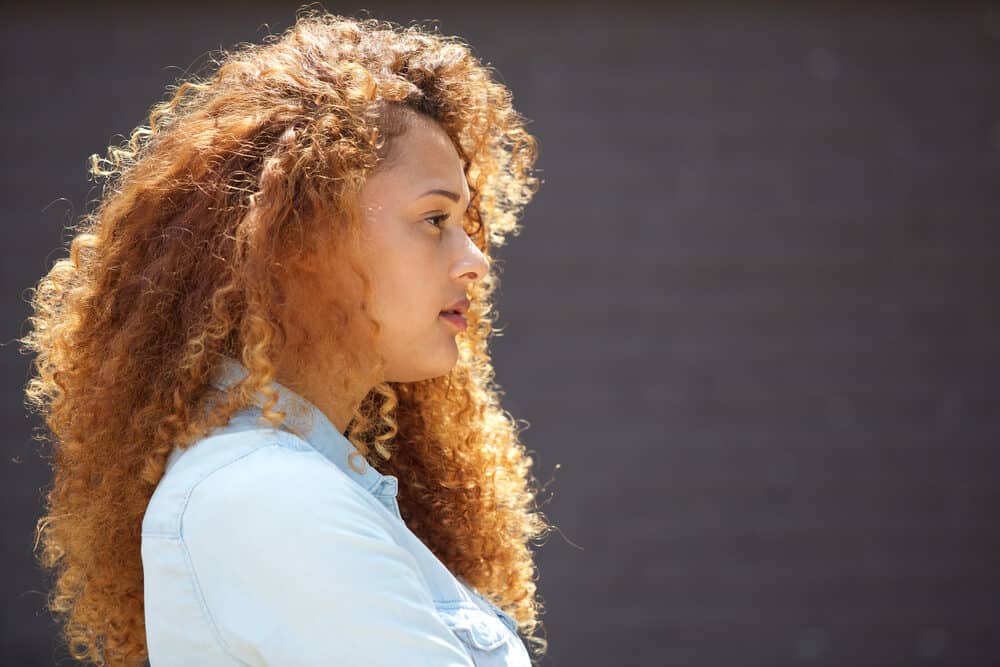 Cute girl with natural curls styled with DIY hair products that contain aloe vera and moisturizing soy proteins