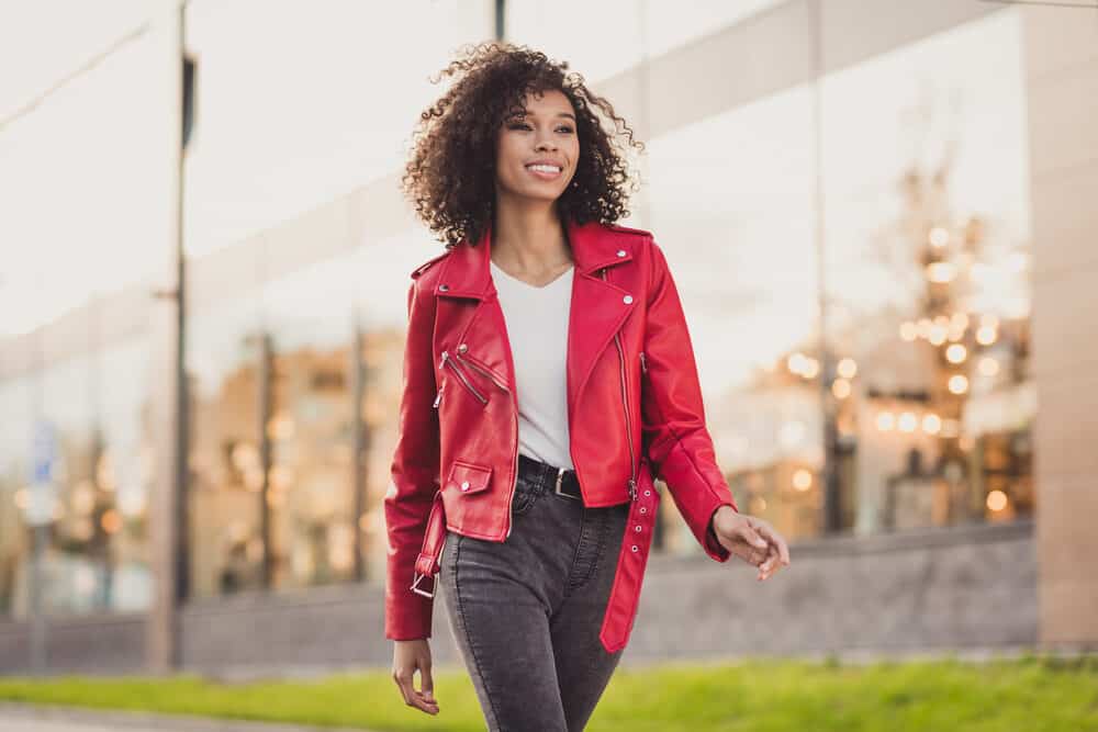 Black woman with damp hair recently dyed brown with semi-permanent hair color.