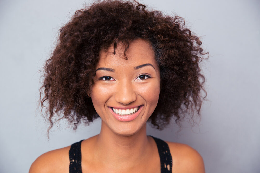 Black female with thick hair density wearing organic skin and hair products to avoid hair lank and silicone buildup.