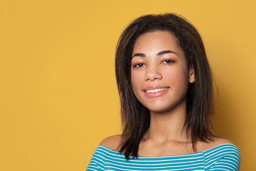 African American woman with a very thick hair type wearing her hair in a bob hair cut.