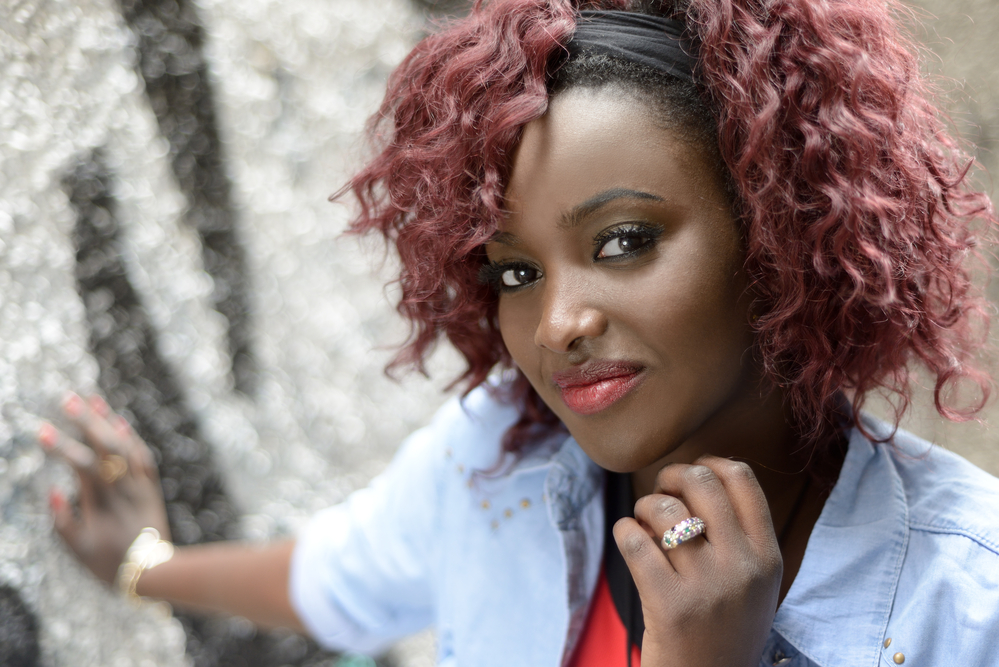 Lady with black dyed hair wearing an engagement ring on her ring finger.