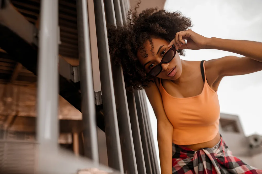 When a Guy Compliments Your Hair What Does It Mean? Does He Touch It? 3 An adult female that's a natural beauty is sitting outside wearing a new hairstyle and organic make-up.