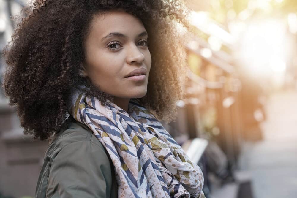 Attractive girl with lightly bleached hair with minimal damage standing outside