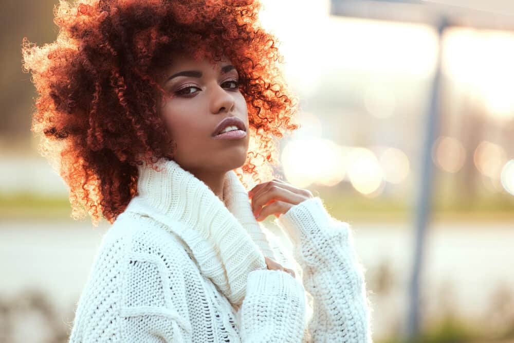 African American with a curly afro styled with Overtone hair dye and an olive oil mask.