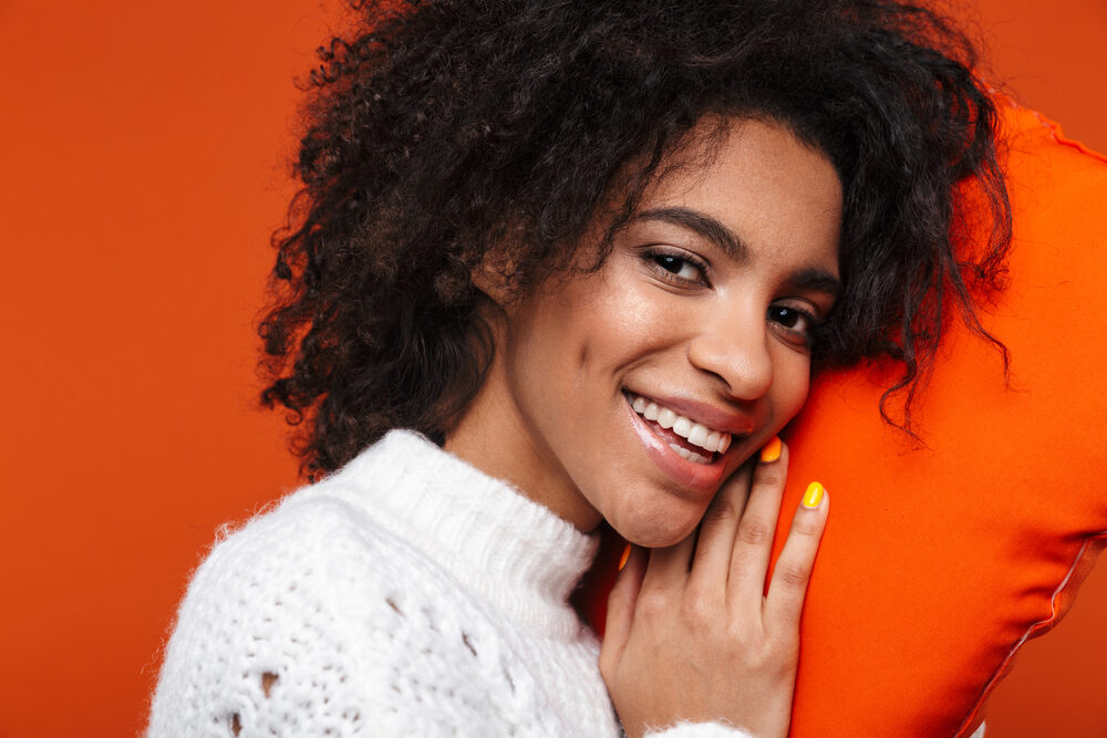 African American female with naturally brown hair that's dyed darker with a strong coffee mixture.