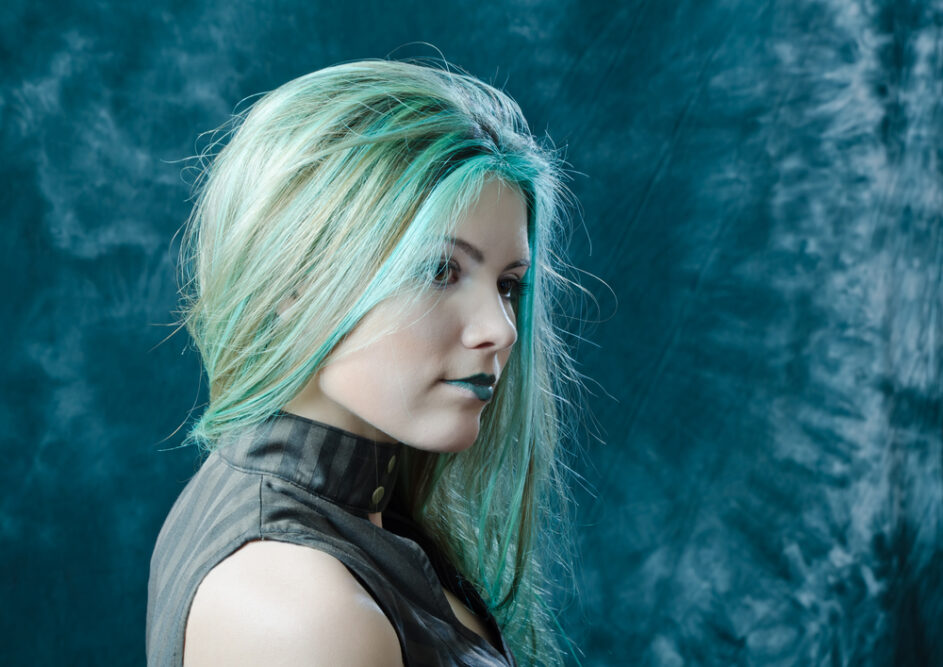 Young girl with bleached blonde hair that turned a green shade after a hair dyeing disaster.