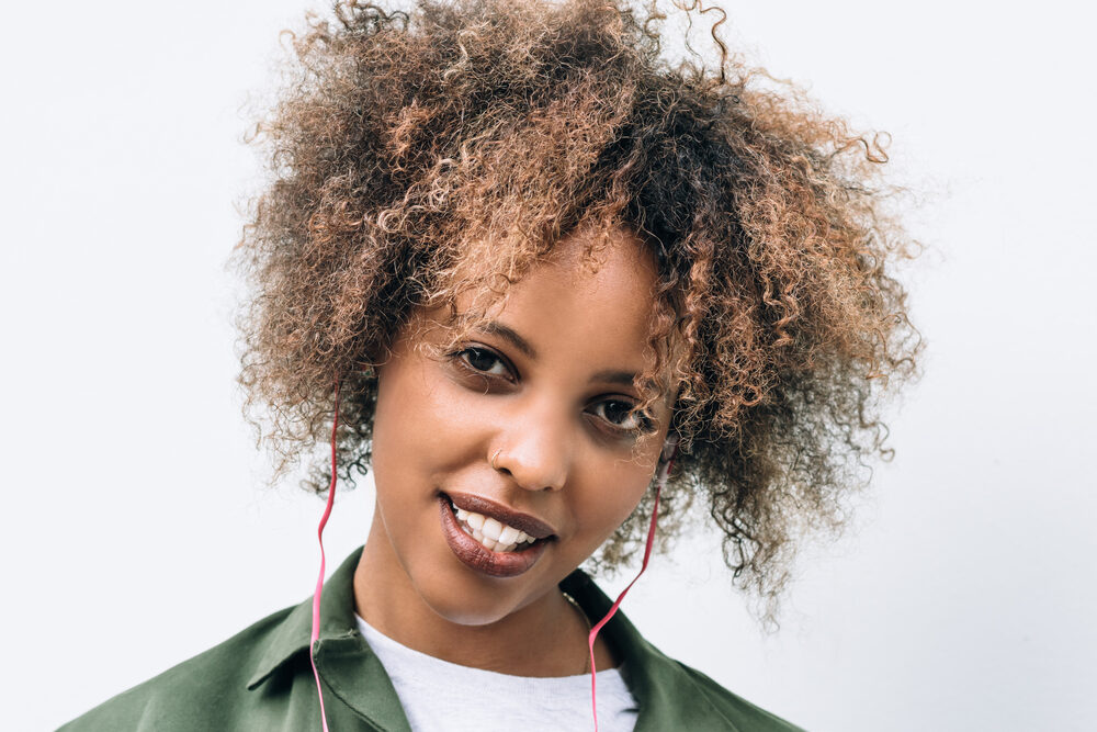 Cute black girl with 3C hair wearing a wash n go - a popular trend for curly hair girls.