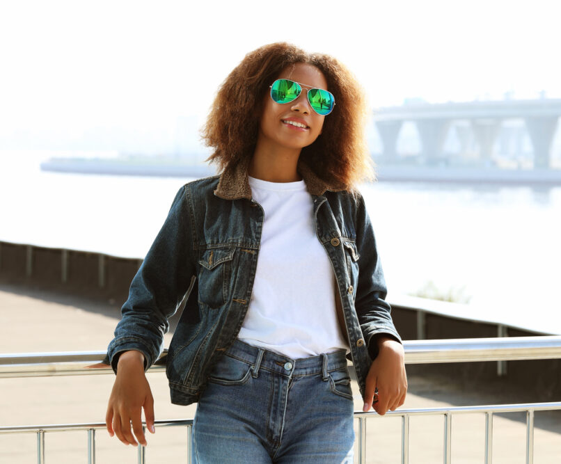 Black girl with a stubborn bed head style that is sticking up all over her head after a bad hair cut.