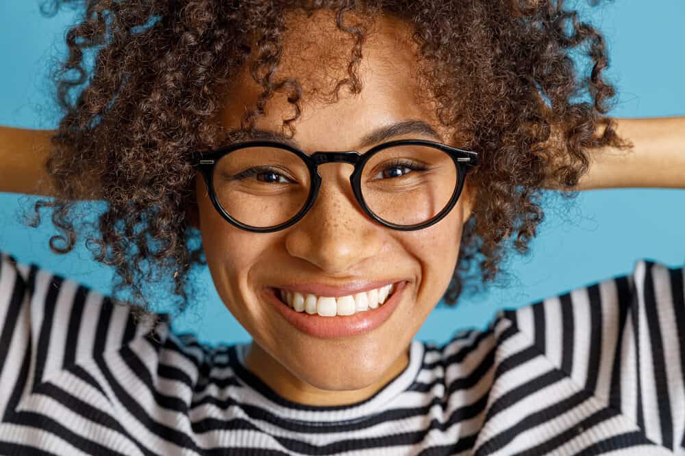 Joyful multiethnic female with red-dyed hair with Jell-O dip dye.