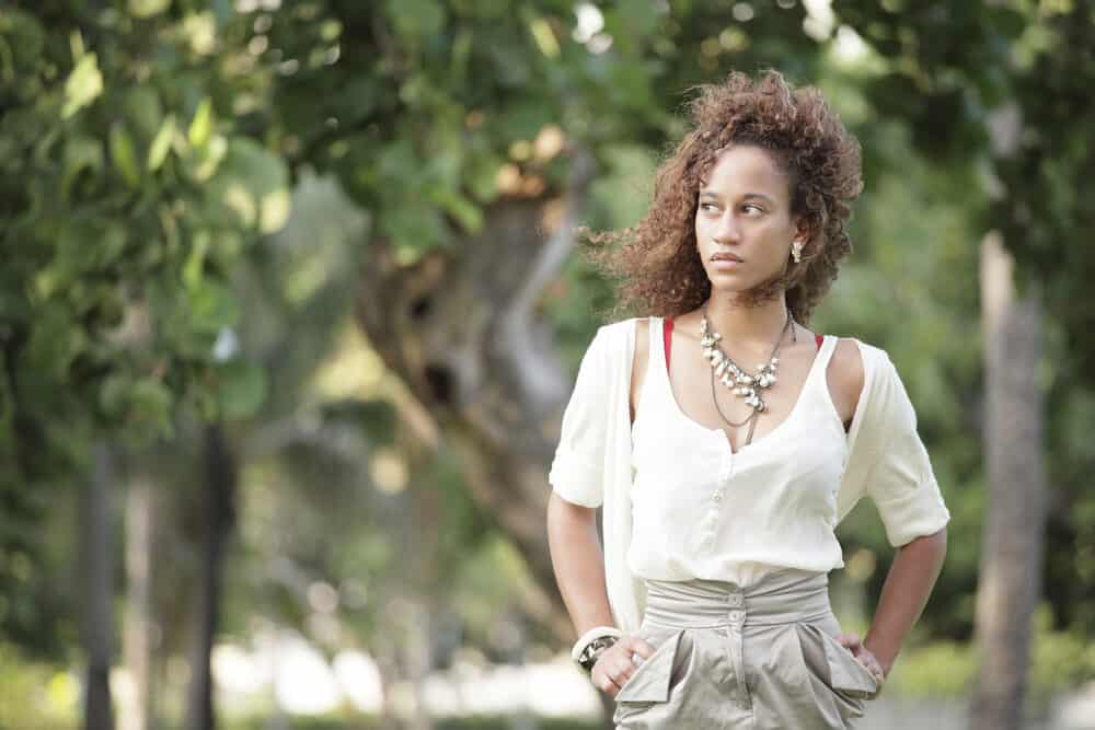 Black woman with bleached hair with unwanted yellow tones fades in the sunlight.