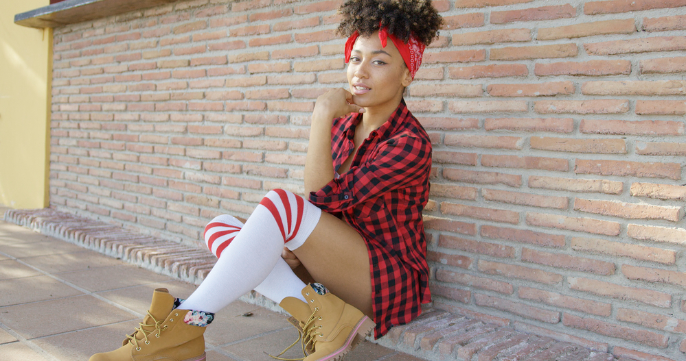 Chic woman in a trendy outfit with fine hair in a pineapple updo created with argan oil and a wide-tooth comb.