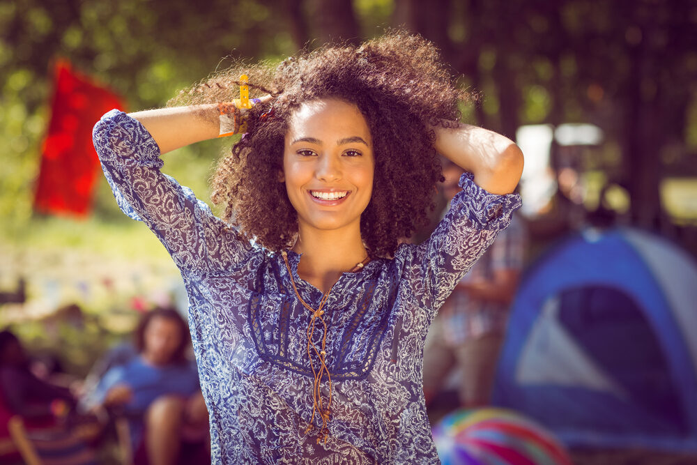 A cute black female with beautiful curls after shampooing her hair because corn starch sucks.