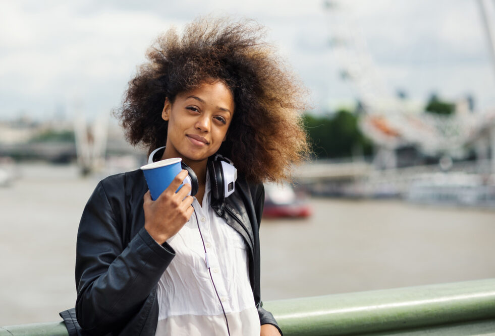 Cute black girl with light brown hair tips colored with semi-permanent dye.