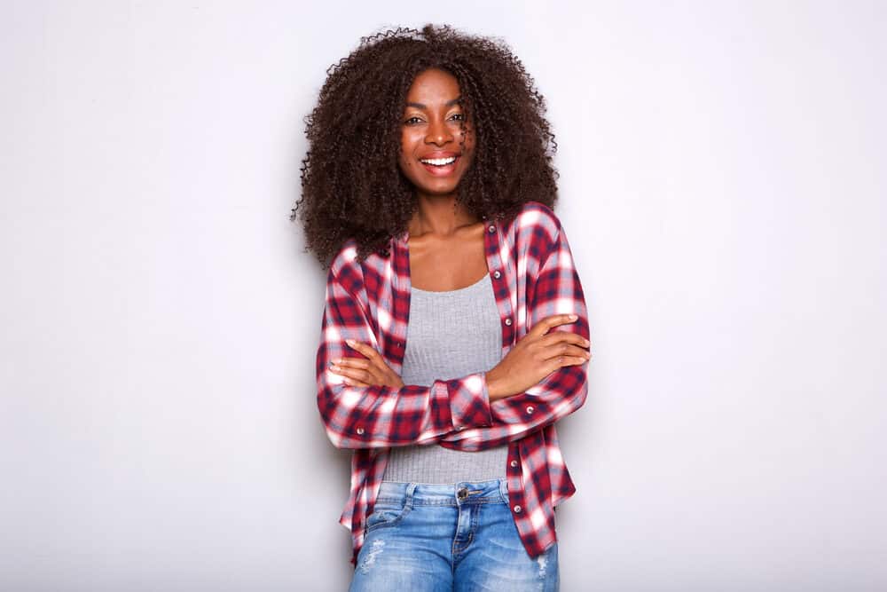 Portrait of a beautiful African-American lady standing with her arms crossed after leaving the nail salon.