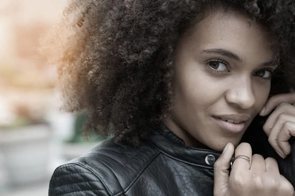 Cute light-skinned black girl with naturally curly hair with dark brown pigments